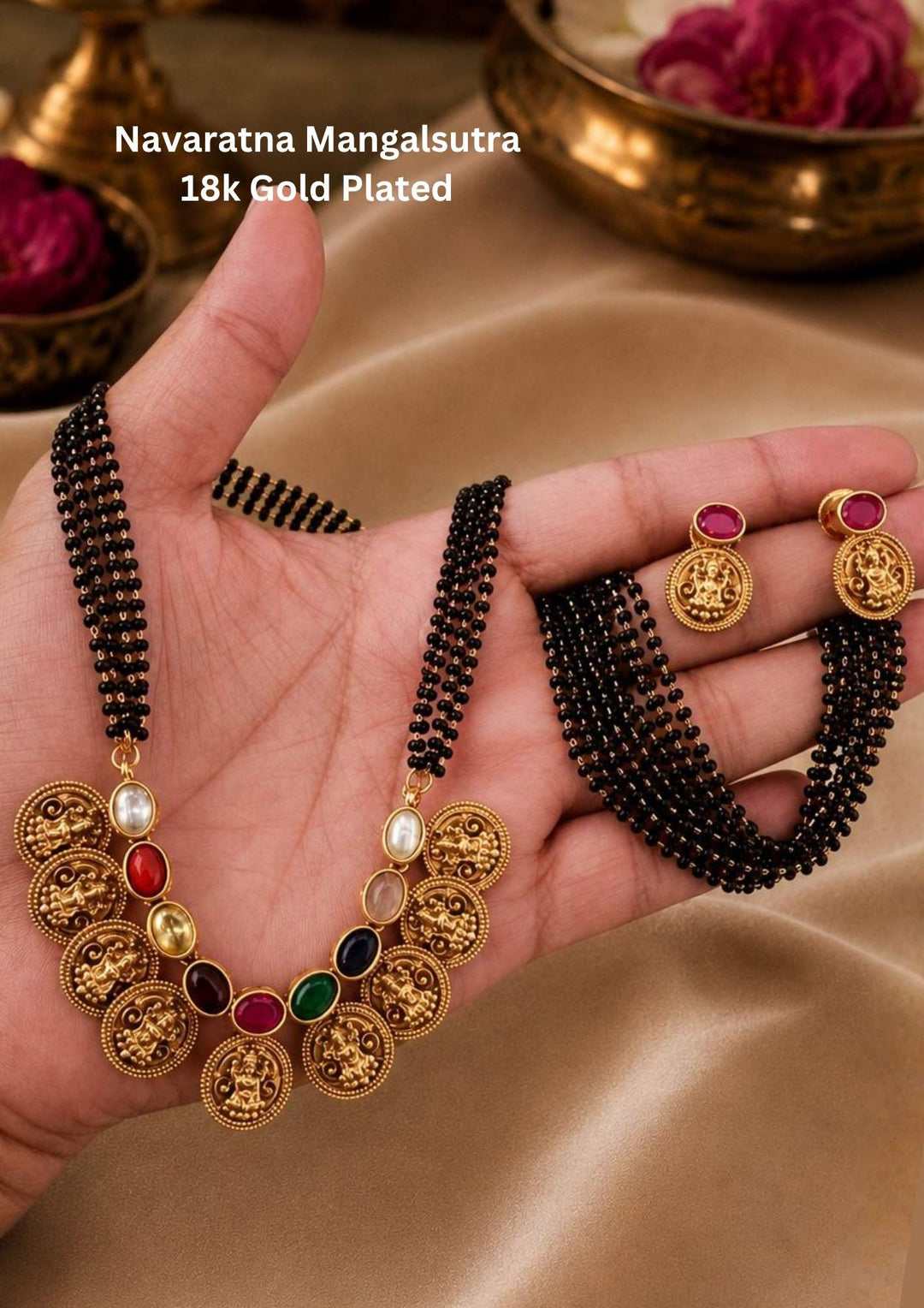 18k gold plated mangalsutra featuring a multi-strand black bead chain connected to a crescent of gold Lakshmi coins interspersed with colorful Navaratna gemstones. Includes matching gold Lakshmi coin earrings.