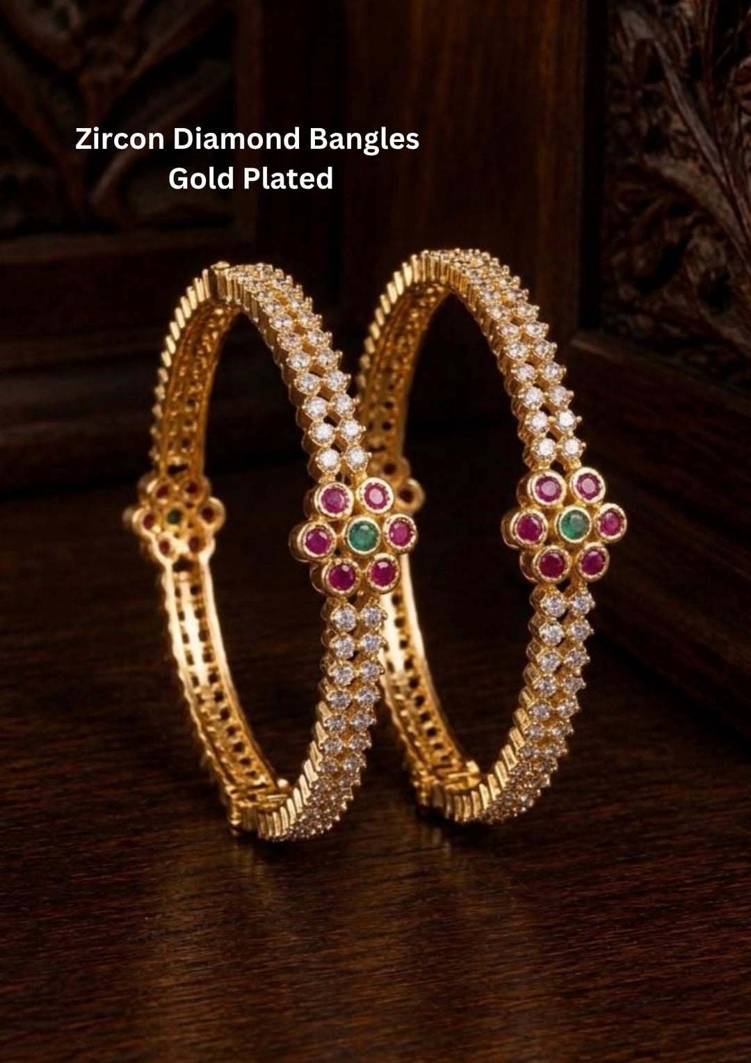 Zircon diamond gold plated bangles pair featuring multiple rows of glistening white zircon stones highlighted by a prominent central floral cluster made of rich ruby pink petals and a green emerald core. This premium kada style set provides a heavy statement look while remaining lightweight and comfortable, suitable for weddings, festivals, receptions, family gatherings, sarees, lehengas, and ethnic outfits with skin-friendly quality, anti-fade polish, secure fitting, and Cash on Delivery available now.