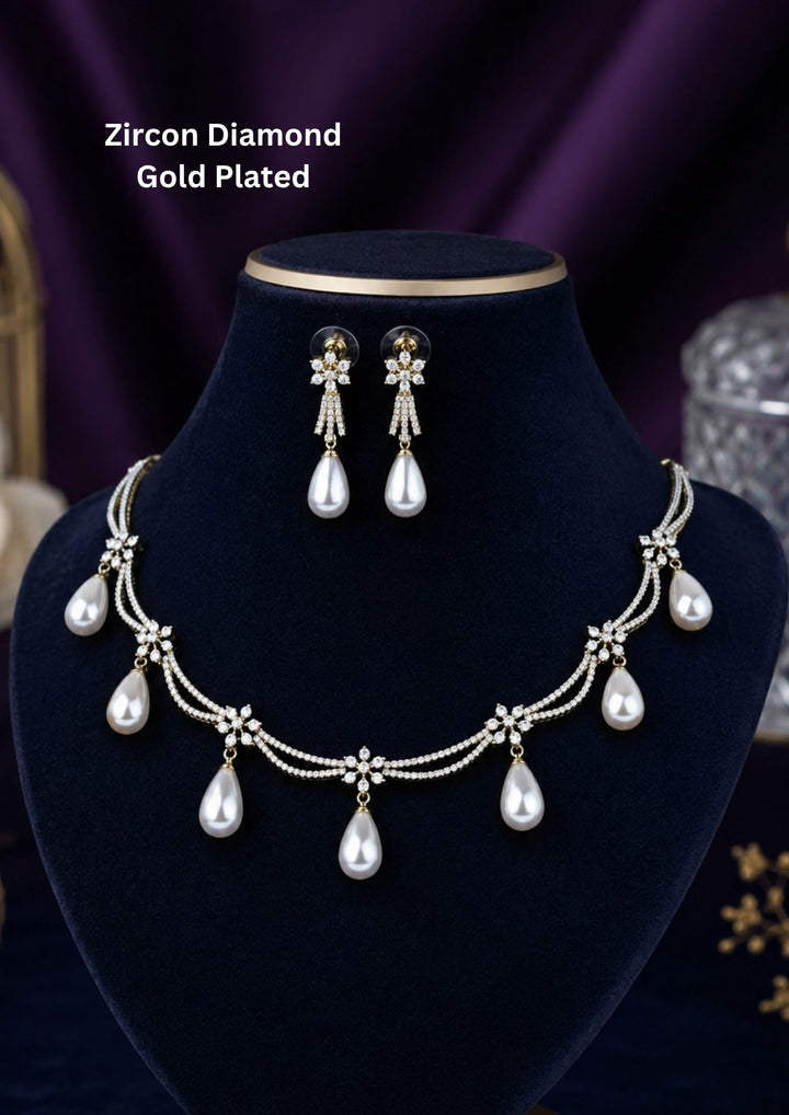 gold plated collar necklace crafted with a double-layered scalloped swag design, heavily paved with shimmering pure Zircon diamonds and accented with small flower star stations. Suspended from the swags are seven perfectly matched, smooth cream-white teardrop pearl drops, complete with matching pearl dangle earrings.