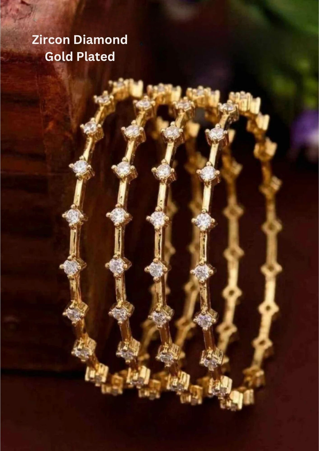 A set of four ultra-slim 18k gold plated eternity-style bangles encrusted with premium pure Zirconian diamonds. Each bangle features a continuous row of brilliant round white crystals secured in delicate square prong settings spaced evenly along a fine golden wire frame. The set is lightweight, highly durable, and skin-friendly.
