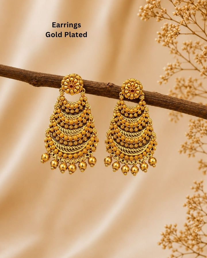 Premium gold plated traditional jhumka earrings featuring detailed floral motifs, multiple ornate layers, and delicate gold bead drops. Perfect for weddings, festive occasions, traditional wear, parties, and gifting.
