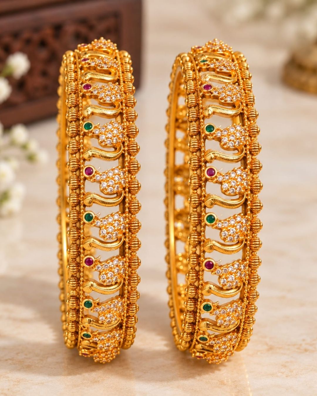 Premium gold plated designer bangles featuring repeating floral zircon motifs with textured gold bead detailing. Perfect for traditional wear, festive occasions, weddings, and gifting.