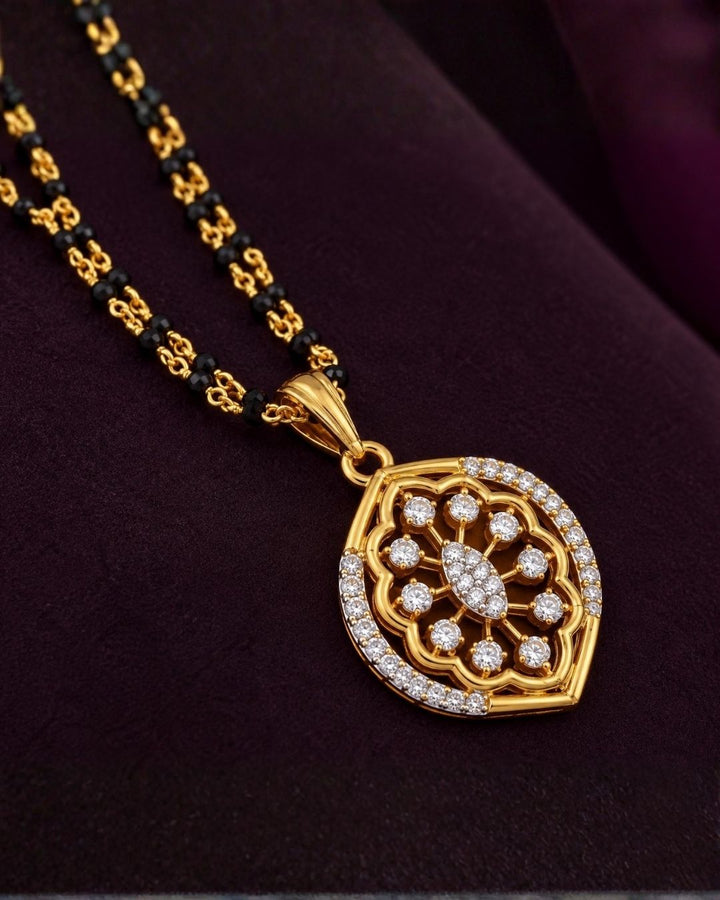 Elegant gold plated mangalsutra set with zircon diamond pendant, matching earrings and premium black bead chain.erfect for everyday elegance.