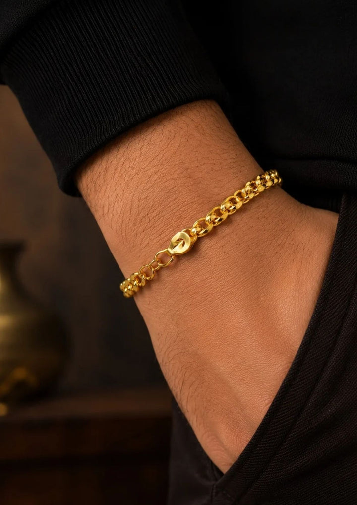 A close-up of a south indian man wrist wearing Elegant gold plated bracelet for men crafted with polished curb links and an adjustable clasp, perfect for daily wear, parties, traditional outfits, and gifting.