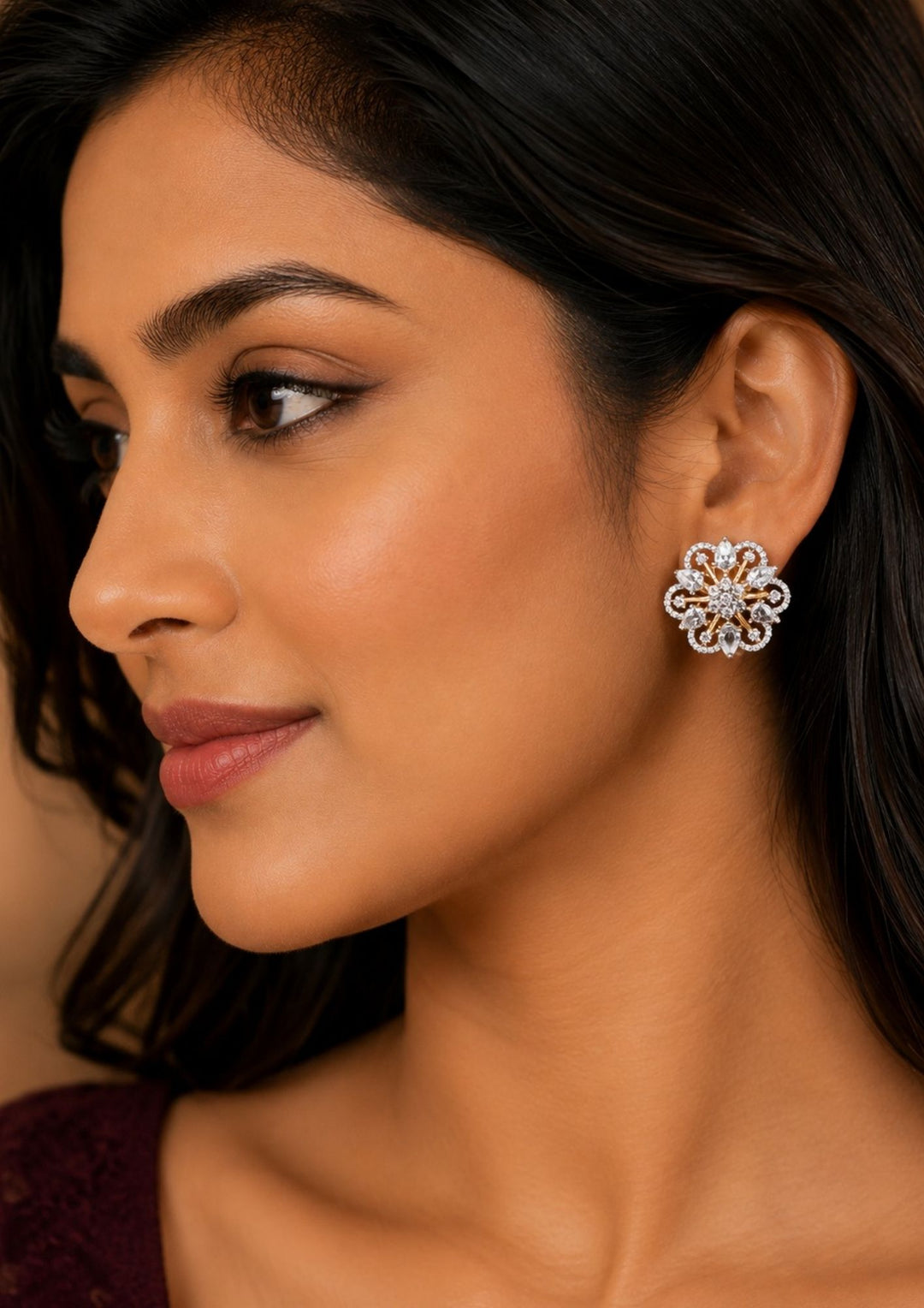 Close up of a South Indian women wearing a Elegant zircon diamond gold plated floral stud earrings featuring sparkling pear-cut and round zircon stones arranged in a luxurious flower design. Perfect for daily wear, parties, and festive occasions.