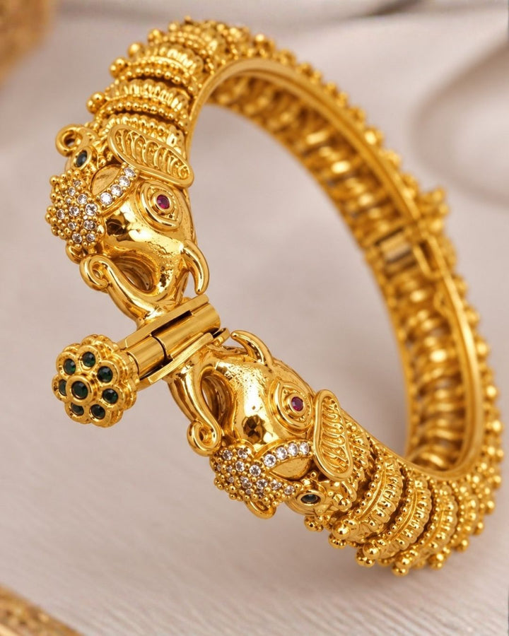 Elegant gold plated openable Kankanalu kada featuring beautifully detailed elephant motifs, intricate traditional patterns, and a polished gold finish, perfect for festive and traditional wear.
