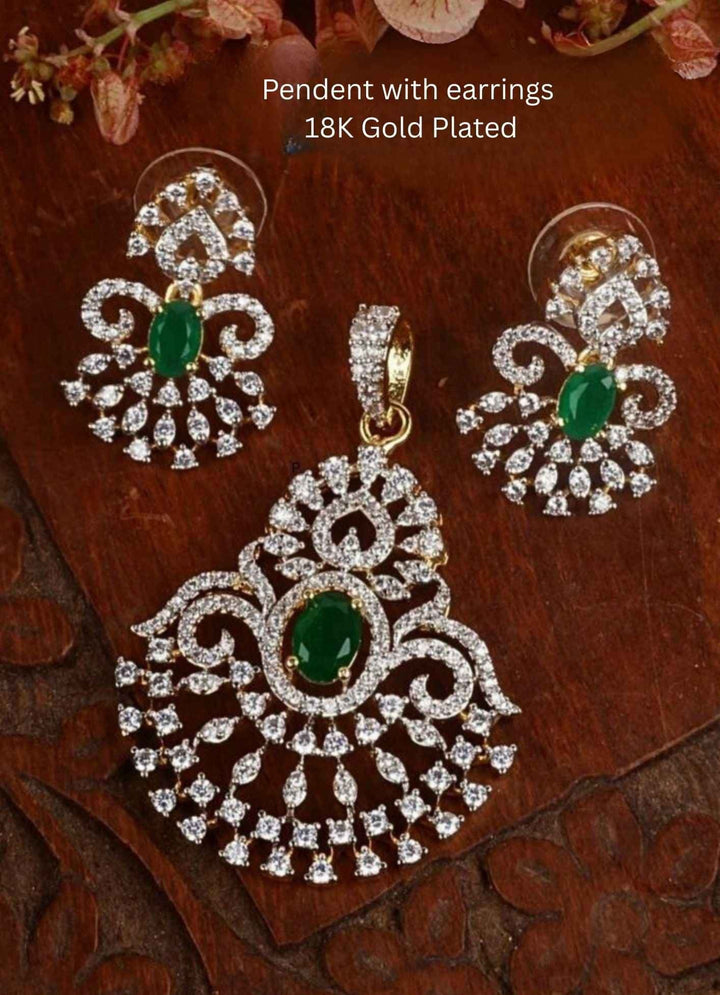 Gold-plated pendant necklace and matching earrings The pendant and matching earrings feature intricate silver-toned filigree with green stone accents in the center.