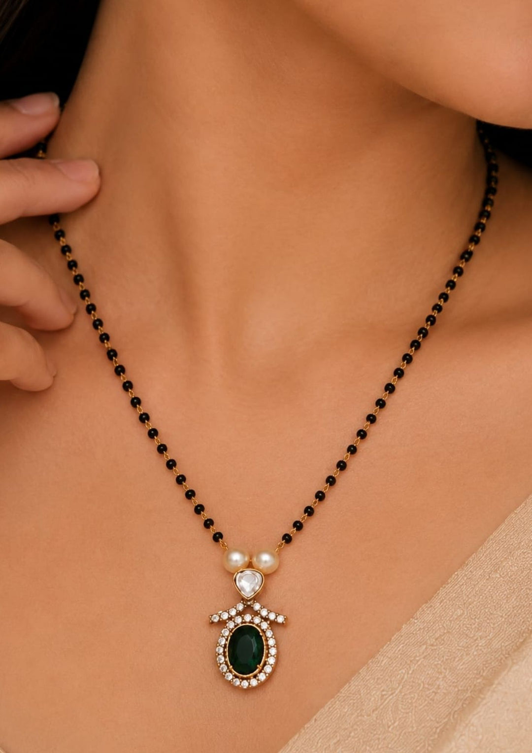 South indian Womens Stylish black bead mangalsutra necklace with an emerald green centerpiece, shimmering zircon stones, and pearl accents, offering a lightweight, elegant design perfect for daily wear, festive occasions, office wear, and gifting.
