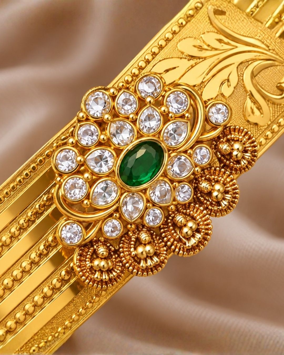 Beautiful gold plated kids hip belt featuring an intricately engraved wide band with floral motifs and a central green gemstone surrounded by sparkling clear stones. Perfect for traditional wear, weddings, festive occasions, cultural celebrations, and gifting.