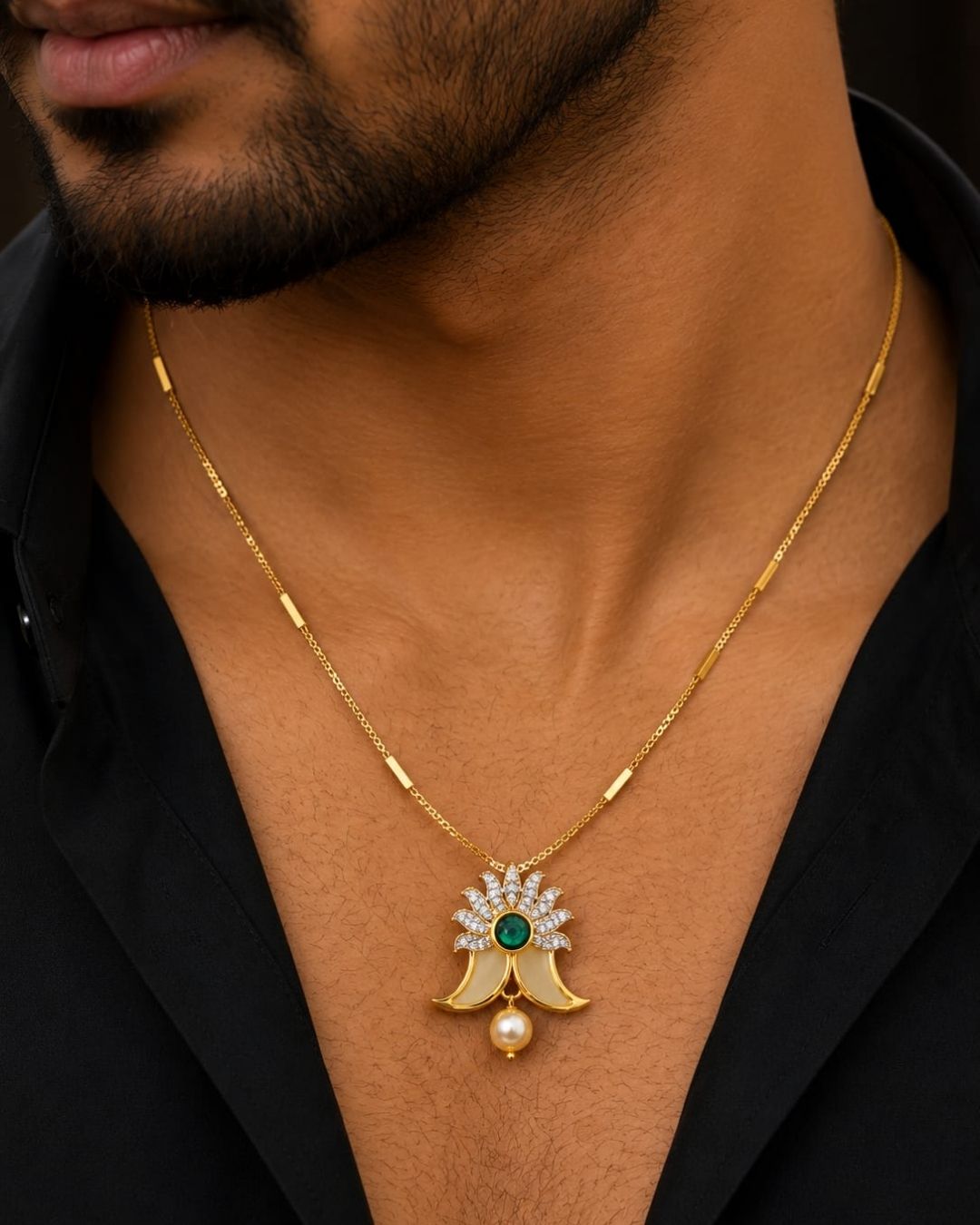 Gold plated Puligoru chain featuring a delicate floral pendant with a green center stone, white stones, and a single pearl drop.