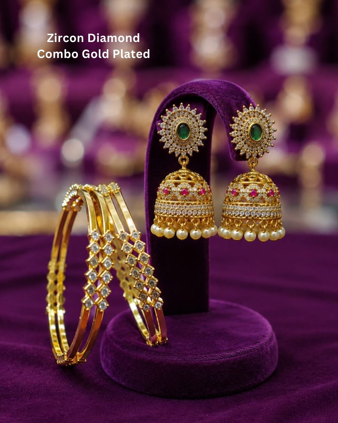 Traditional gold plated bangle and jhumka earrings set featuring CZ stones, green gemstones, pink accents, pearl hangings, and a luxurious velvet presentation for festive occasions.