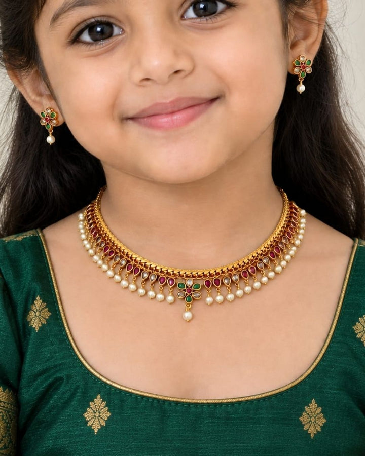 Elegant kids jewellery set with a gold plated necklace, matching earrings, multicolor stones and pearl embellishments.