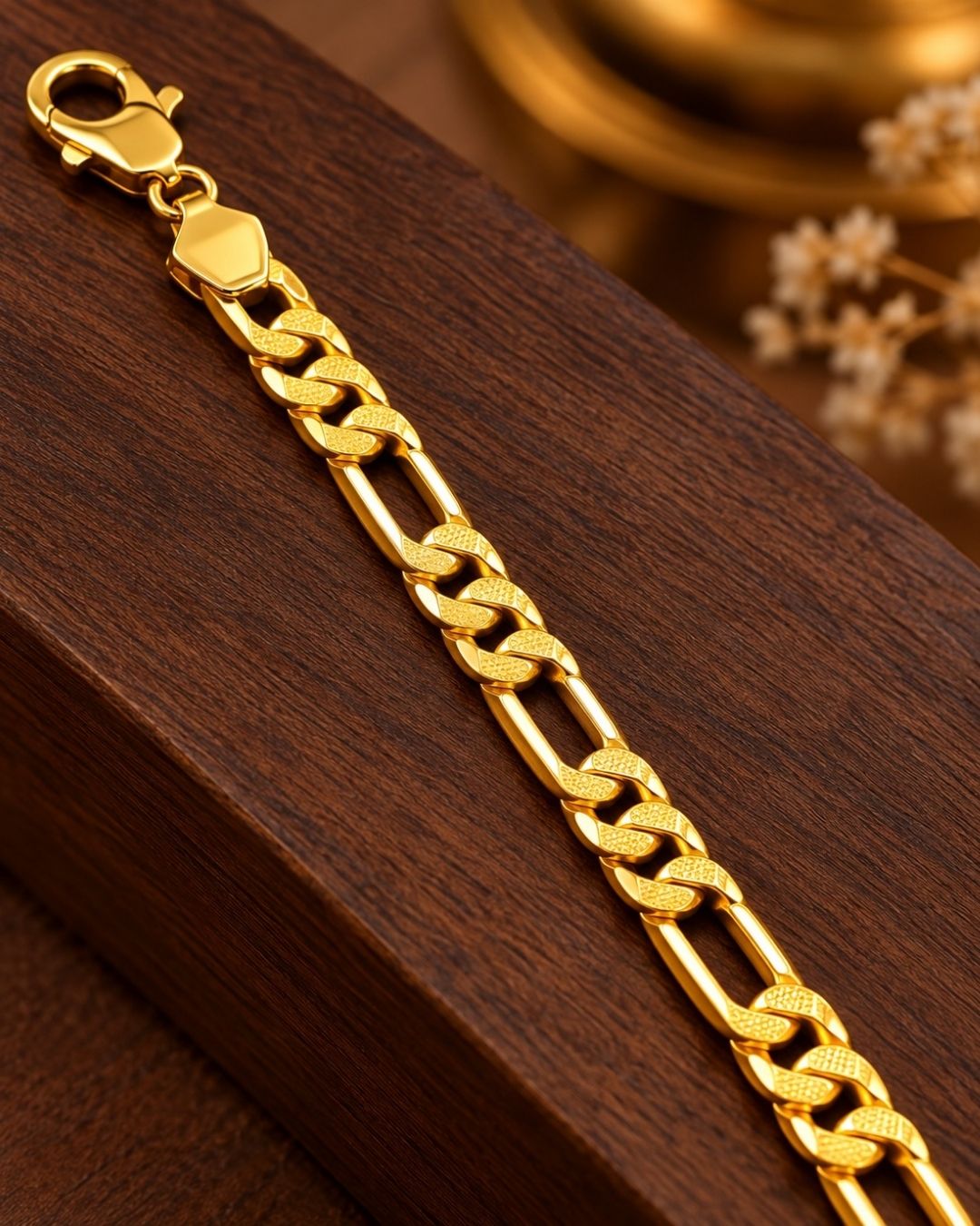 Close up of south indian men wrist wearing An elegant, sleek 18k gold-plated bracelet  features a continuous, sophisticated pattern of repeating cylindrical bar links seamlessly interconnected with small circular loops, offering a clean and polished modern look. Perfect for daily wear or for pairing with your favorite pendant.