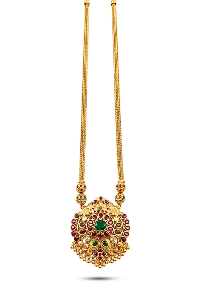 Gold necklace with a detailed pendant on a white background with green and red stones come with jadau kundan in necklace with beads and in pendent shows clear design and in detailed shown in picture it will not fade color and water proof can used for festivals, bridals, and weeding's  
