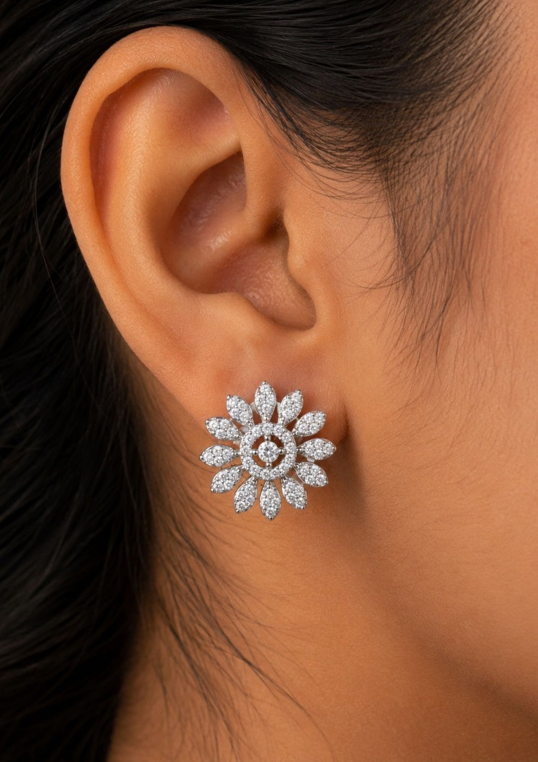 Close-up of an ear wearing a Elegant floral stud earrings crafted with dazzling zircon stones arranged in a blooming flower pattern. The diamond-look finish creates exceptional brilliance, making these studs suitable for daily wear and special occasions.