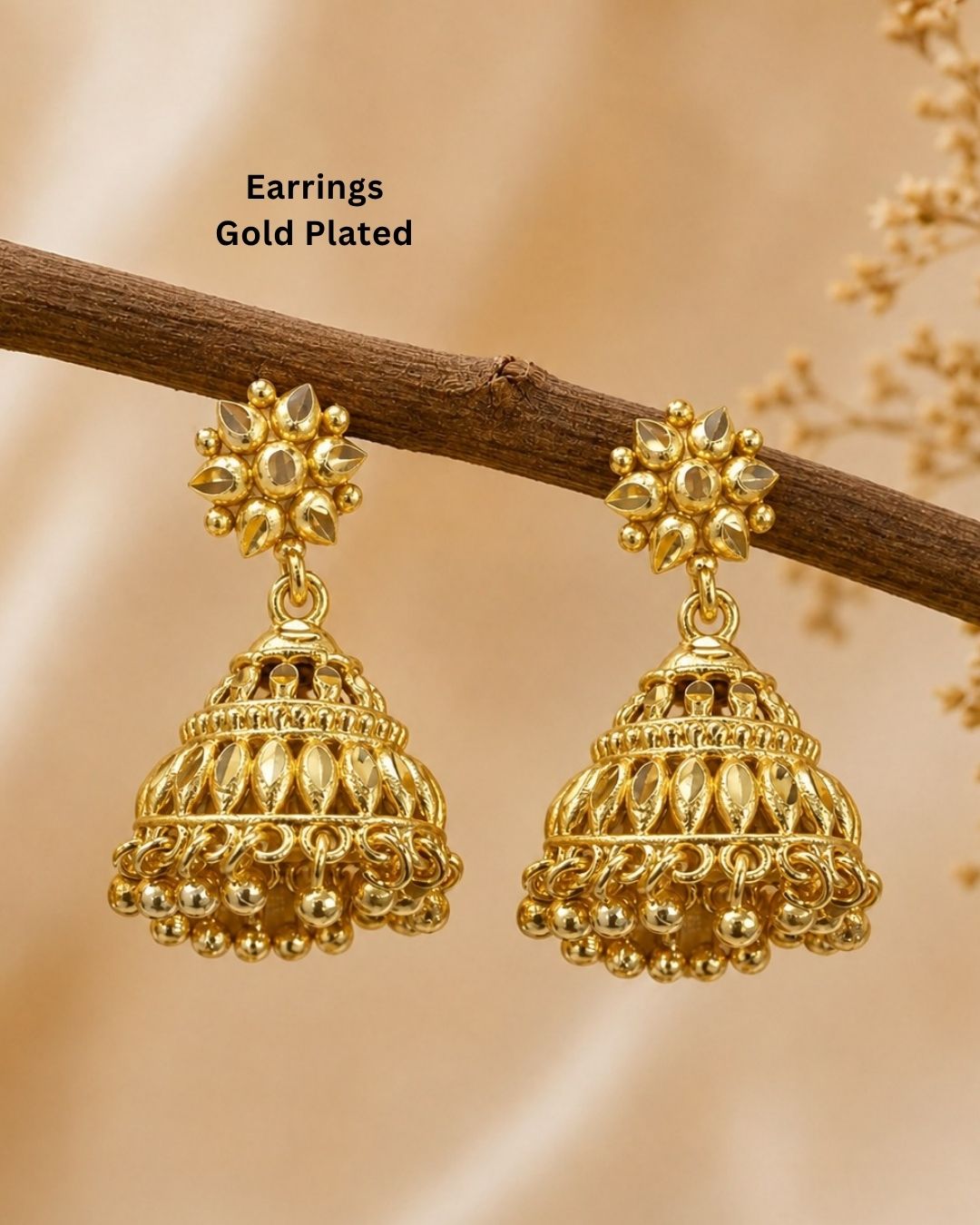 Premium gold plated traditional jhumka earrings featuring intricate floral craftsmanship, detailed dome-shaped designs, and elegant hanging gold bead accents. Perfect for sarees, festive occasions, weddings, classical dance performances, and traditional events.