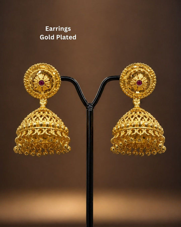 Beautiful traditional gold plated jhumka earrings featuring ornate floral stud designs, red stone accents, intricate filigree-style detailing, and elegant hanging gold beads. Perfect for sarees, festive occasions, weddings, and traditional events.