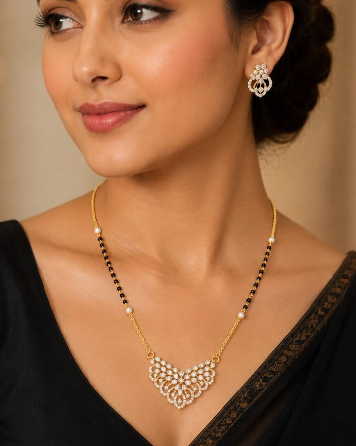 Beautiful black beads gold plated necklace set featuring a detailed floral pendant embellished with sparkling stones, paired with matching floral earrings. Perfect for daily wear, festive occasions, parties, and gifting.