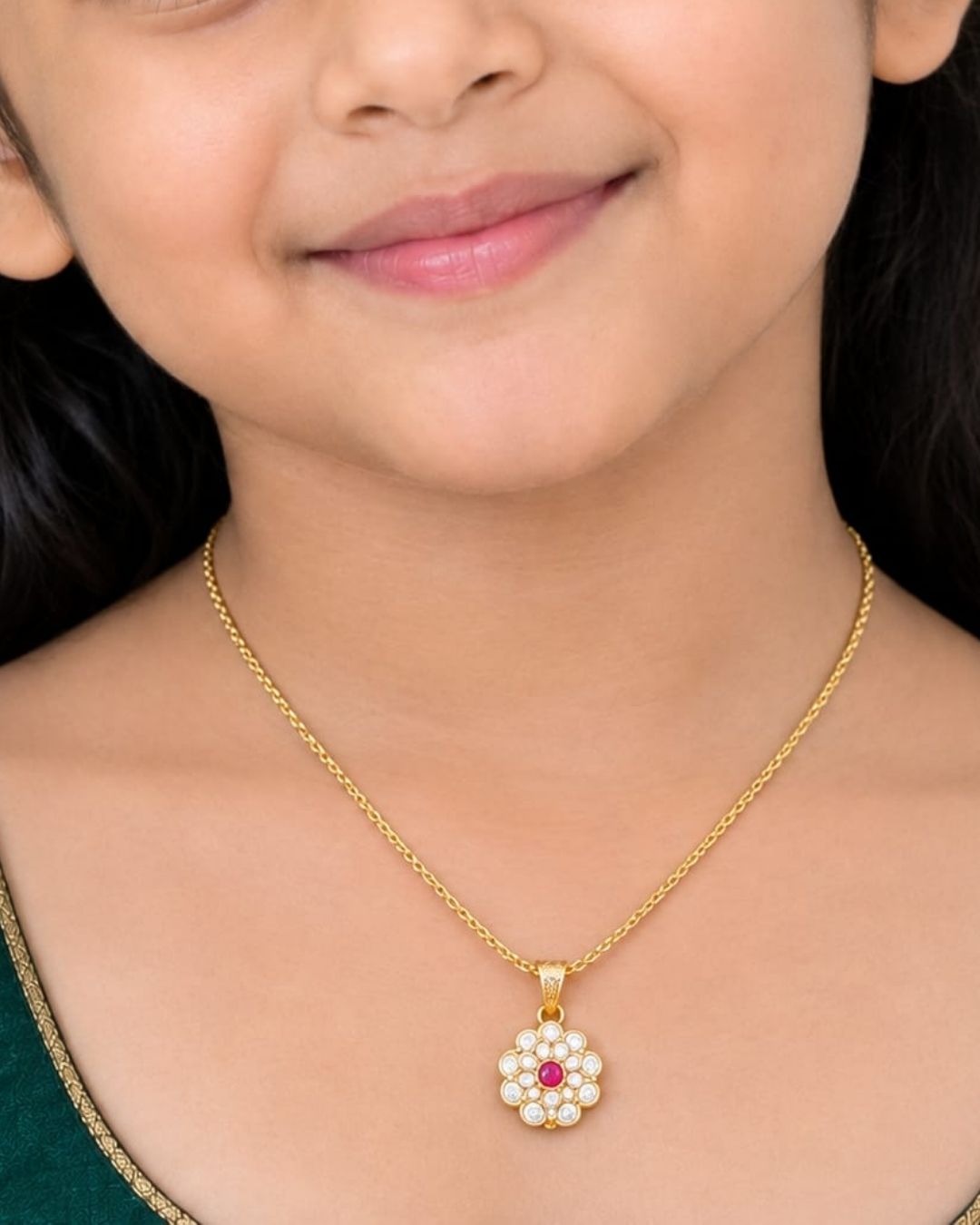 Beautiful gold plated necklace featuring a delicate chain and floral-inspired pendant adorned with sparkling stones and a pink center stone. Perfect for traditional wear, festive occasions, weddings, daily wear, and gifting.