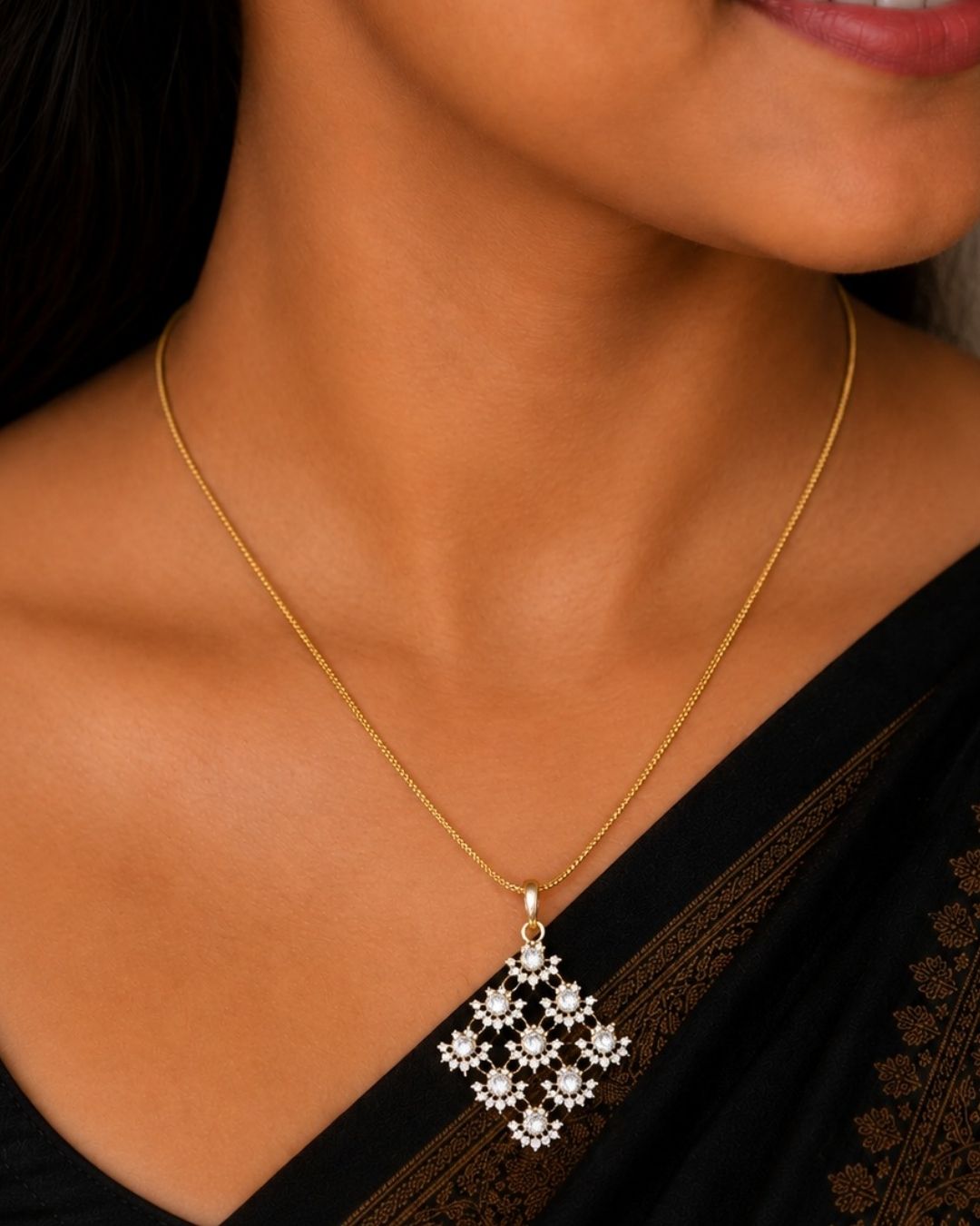 Gold plated chain set featuring a delicate floral-inspired square pendant with sparkling clear stones and matching floral stud earrings.