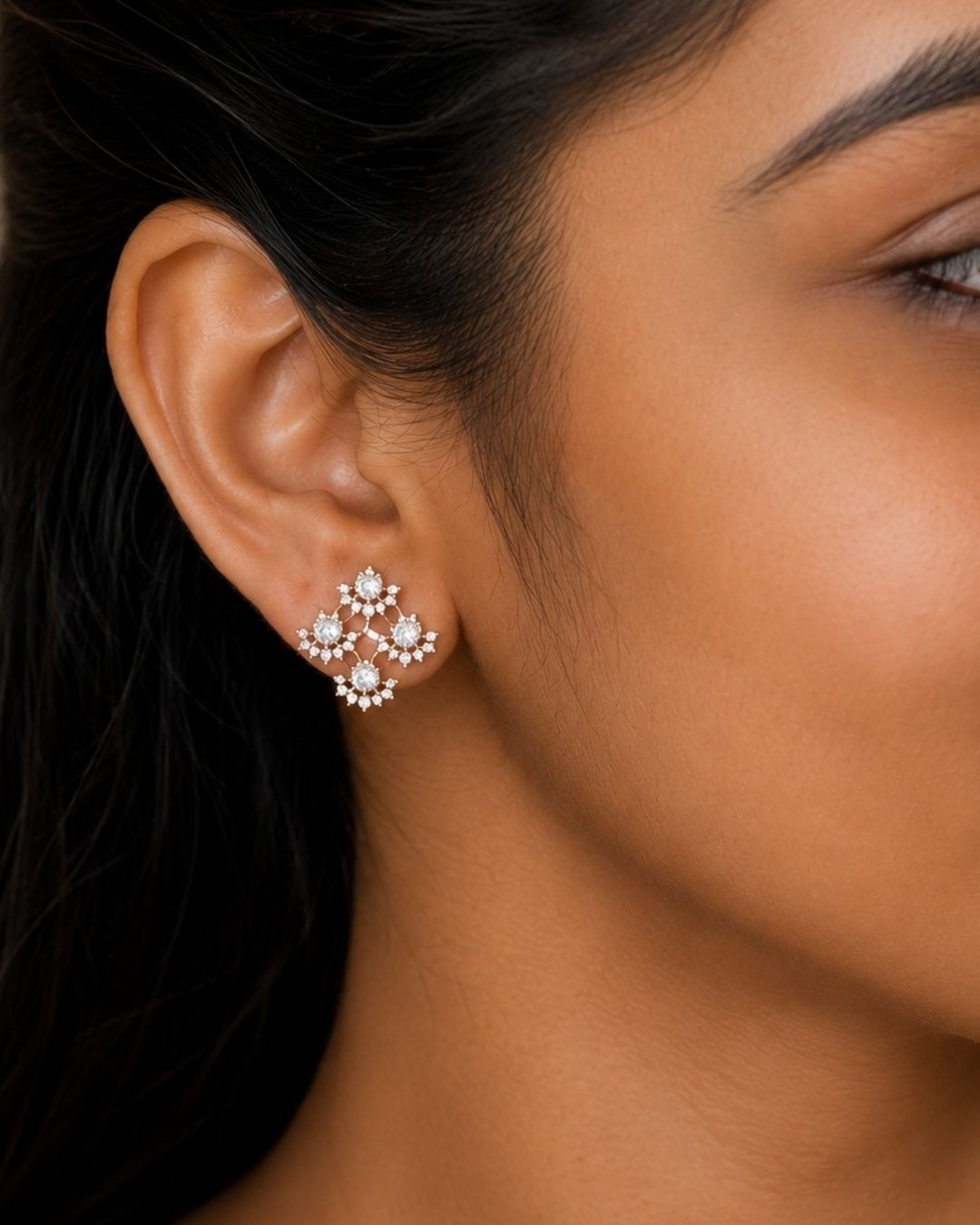 Gold plated chain set featuring a delicate floral-inspired square pendant with sparkling clear stones and matching floral stud earrings.