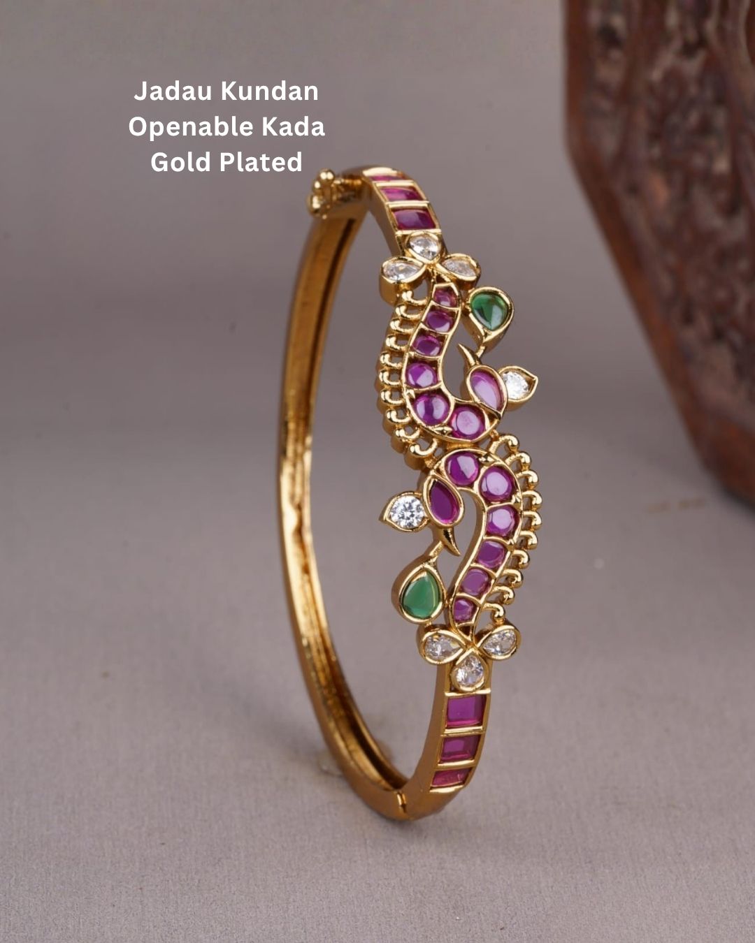 Beautiful gold plated openable bracelet featuring intricate floral detailing embellished with ruby and green stones and sparkling white stones, perfect for festive, traditional, and party wear.