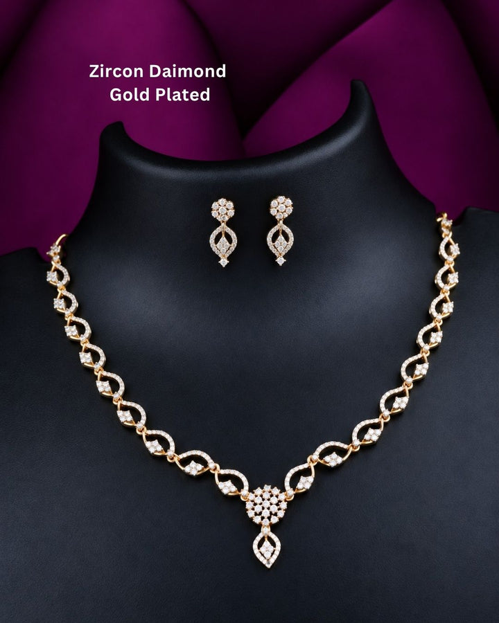 Beautiful gold plated necklace set featuring repeating loop-shaped links embellished with sparkling stones, a floral-inspired pendant, and matching drop earrings. Perfect for traditional wear, festive occasions, weddings, parties, and gifting.