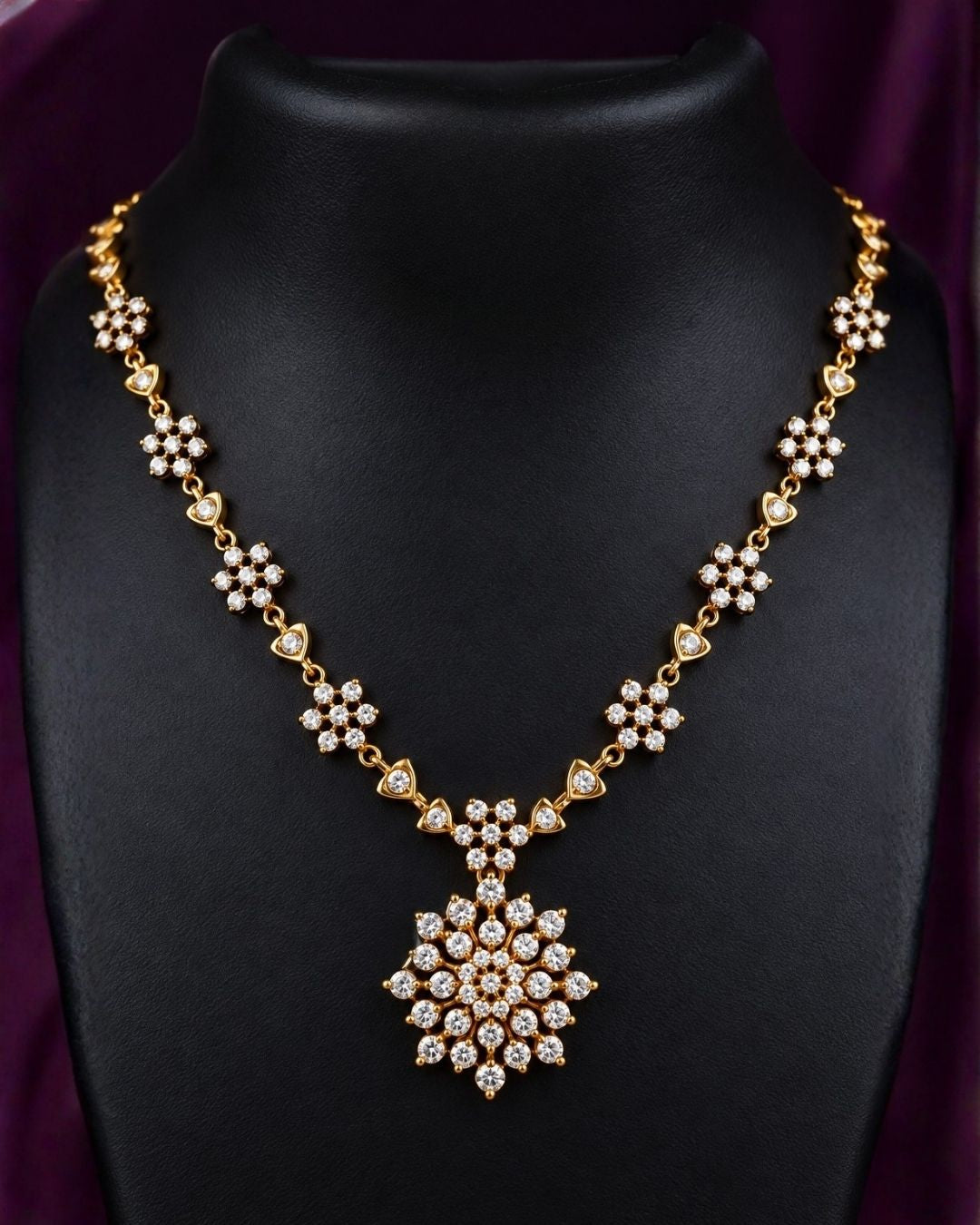 Zircon diamond gold-plated necklace set showcasing an intricate chain linked with tiny floral stone clusters and a beautiful geometric snowflake statement pendant. The matching earrings perfectly mirror the pendant&