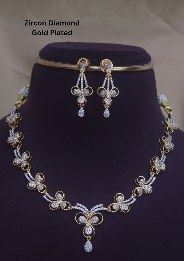 Beautiful zircon diamond gold plated necklace set featuring elegant floral motifs with sparkling zircon stones and matching drop earrings. Perfect for weddings, receptions, and festive celebrations.