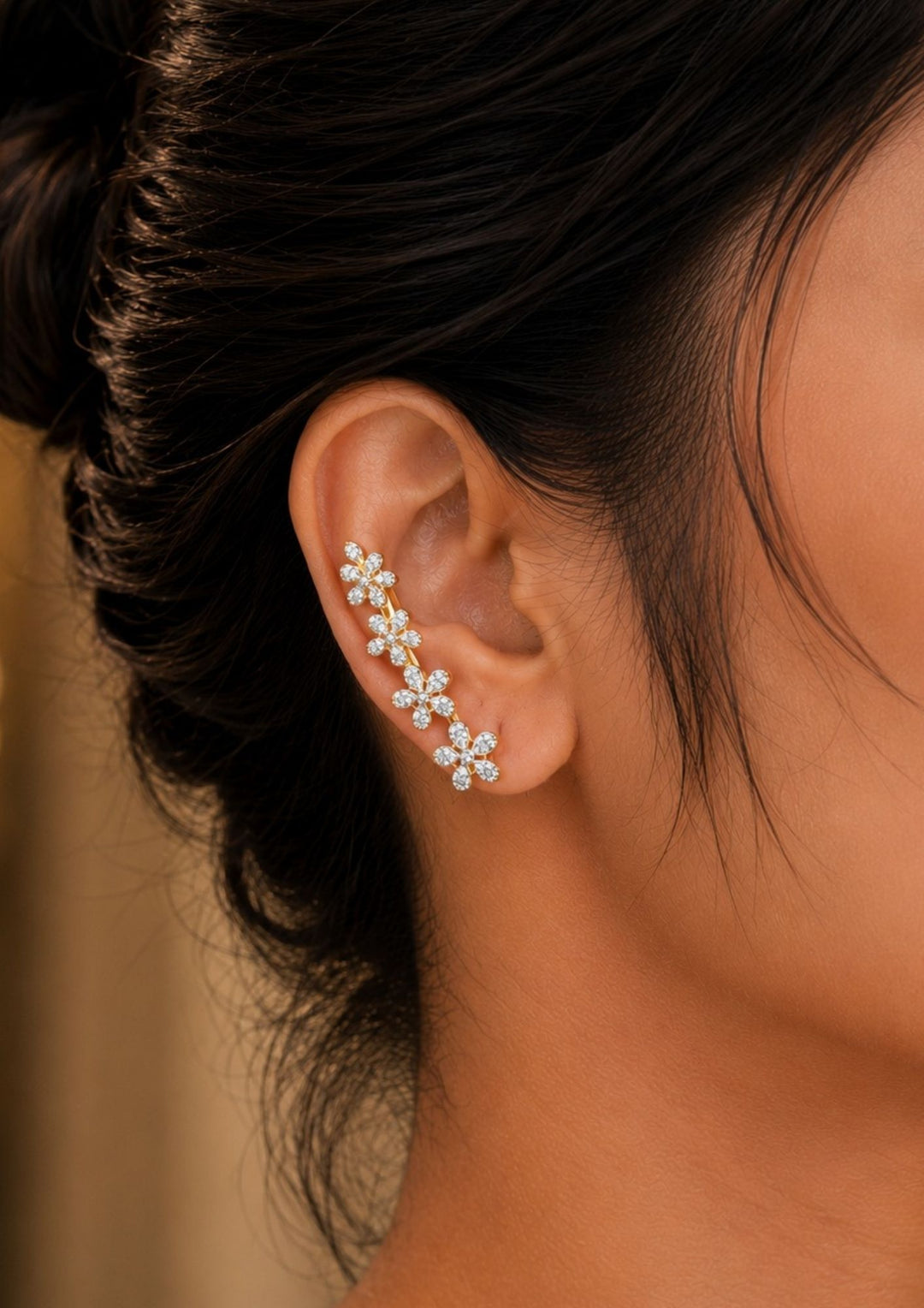 Close-up of South indian womnen ear wearing with a Floral zircon diamond gold plated earrings featuring sparkling white zircon stones arranged in elegant flower petal design with premium gold plated finish and stylish diamond look detailing. These lightweight earrings are crafted with pear cut zircon stones that provide a rich and classy appearance suitable for daily wear, office wear, weddings, festivals, parties, family gatherings,  with skin friendly quality, anti fade polish, 