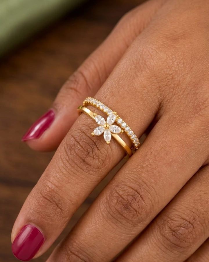 Stylish gold plated adjustable ring with a sparkling floral centerpiece and crystal-studded band, perfect for everyday and occasion wear.