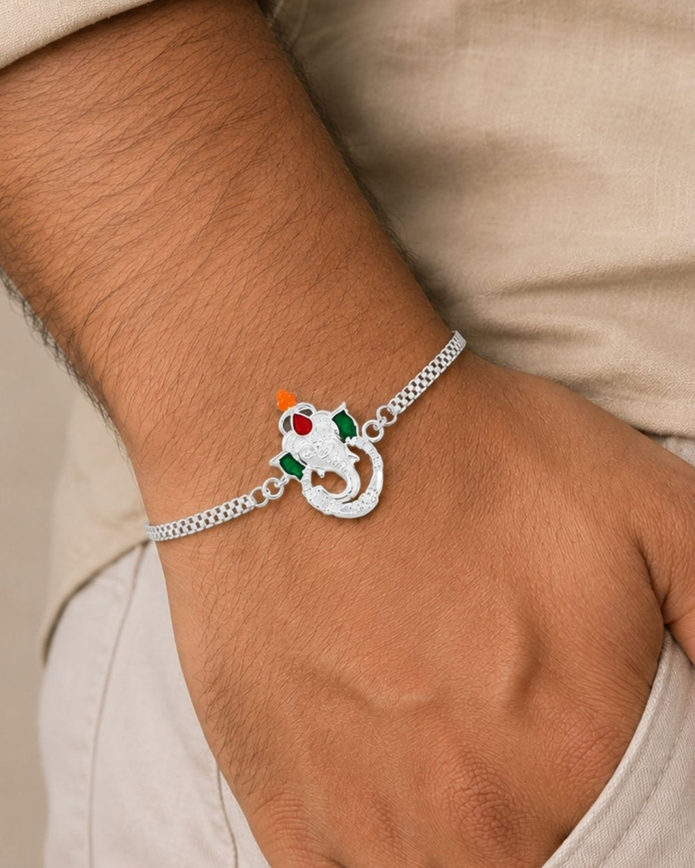 Premium Silver Plated Ganesha Rakhi showcasing a finely detailed Lord Ganesha charm with a polished silver bracelet chain and festive handcrafted design.