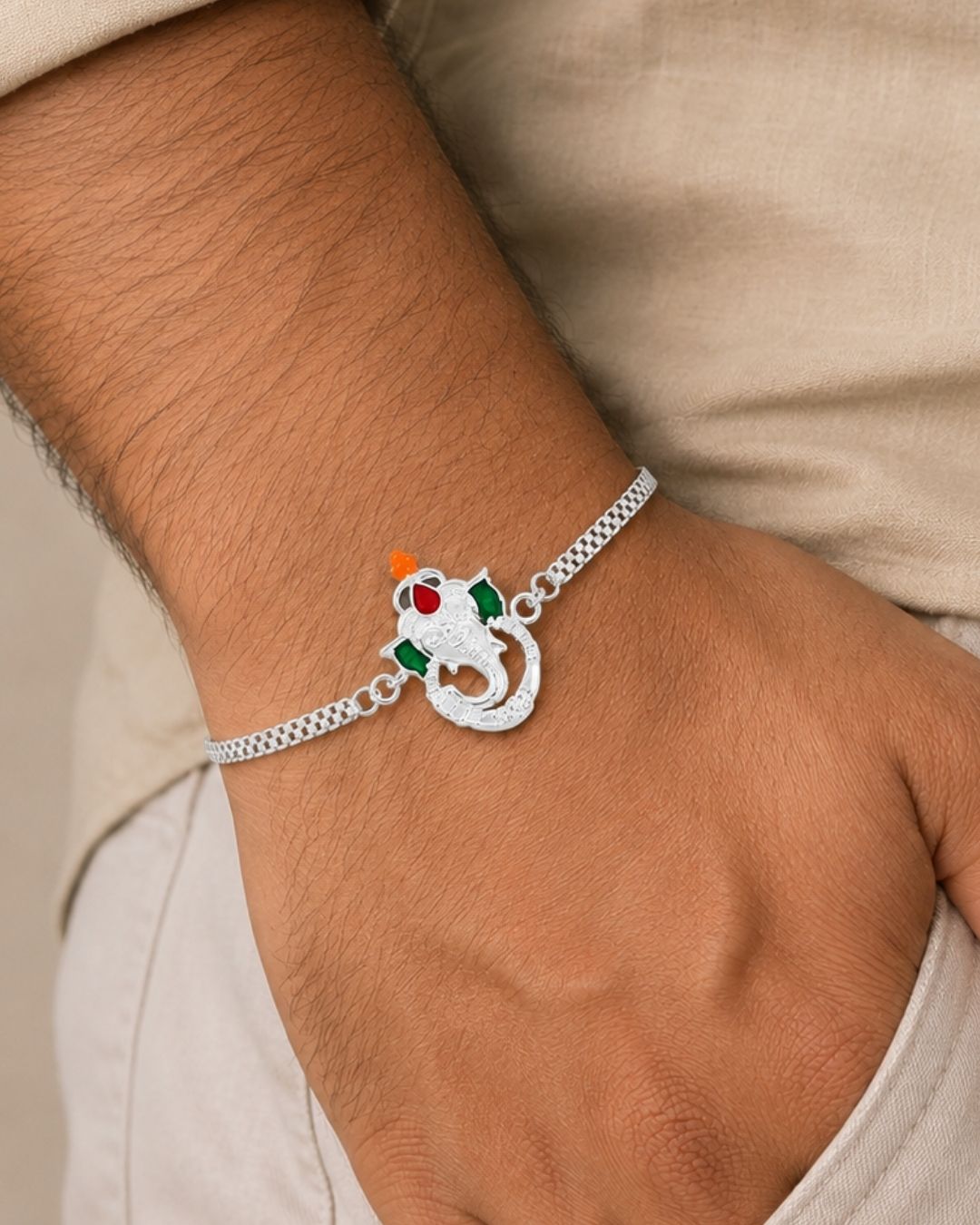 Premium Silver Plated Ganesha Rakhi showcasing a finely detailed Lord Ganesha charm with a polished silver bracelet chain and festive handcrafted design.