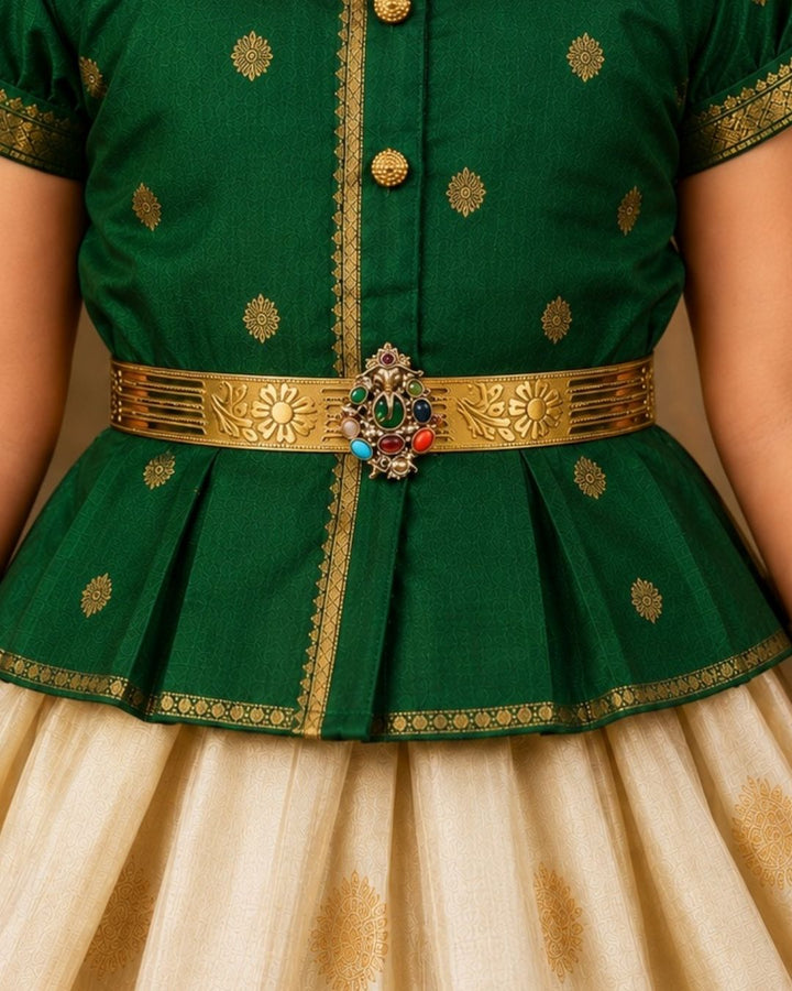 Beautiful gold plated kids hip belt featuring an intricately engraved wide band with floral designs and a central Ganesha motif surrounded by colorful green, red, blue, and white stones. Perfect for girls&