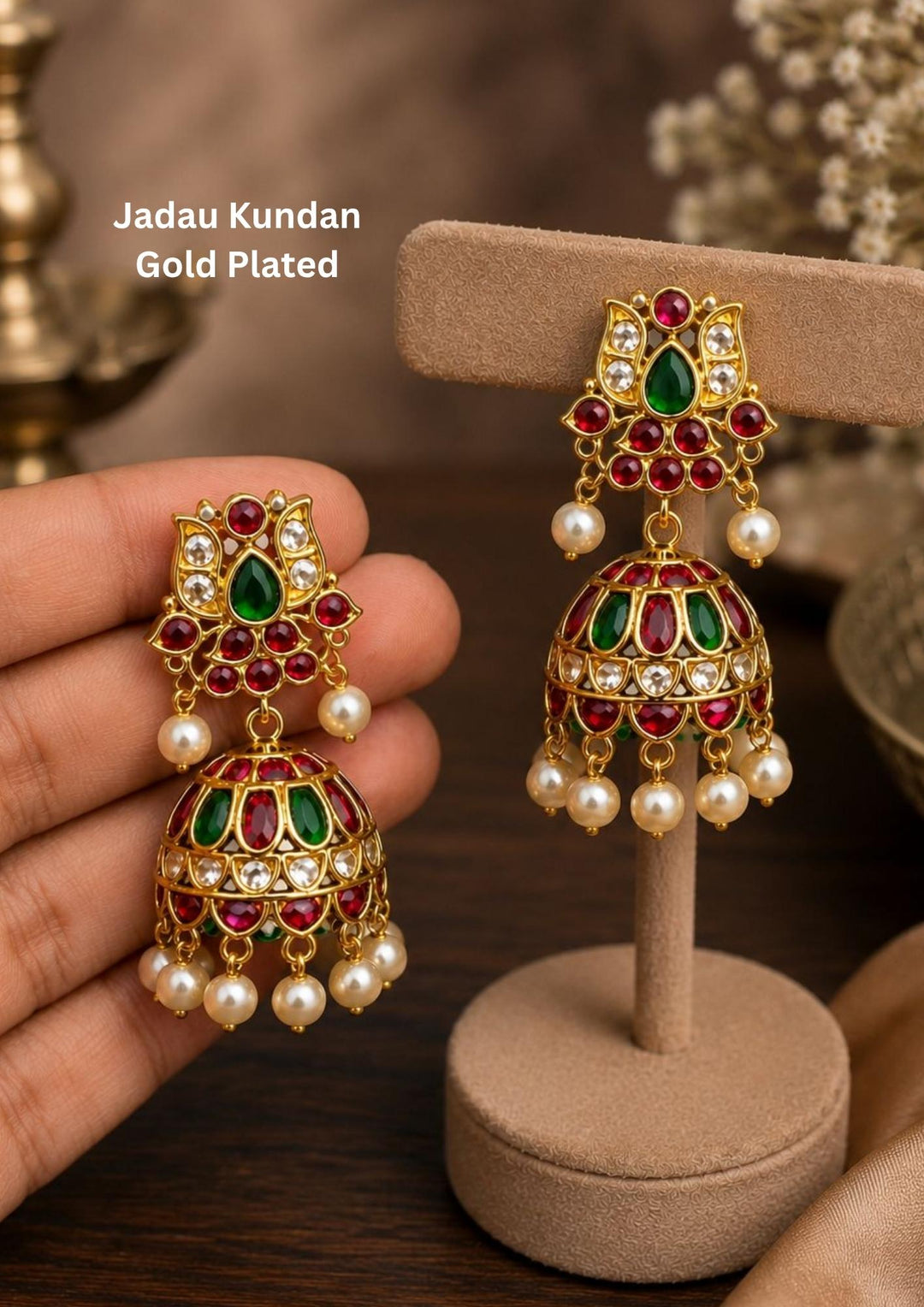 Gold-plated jhumka earrings with green and red stones and bottom with white pearls this jumka is in the shape of trisula on the up side and its is anti fade color perfecr for wedings, poojas and functions