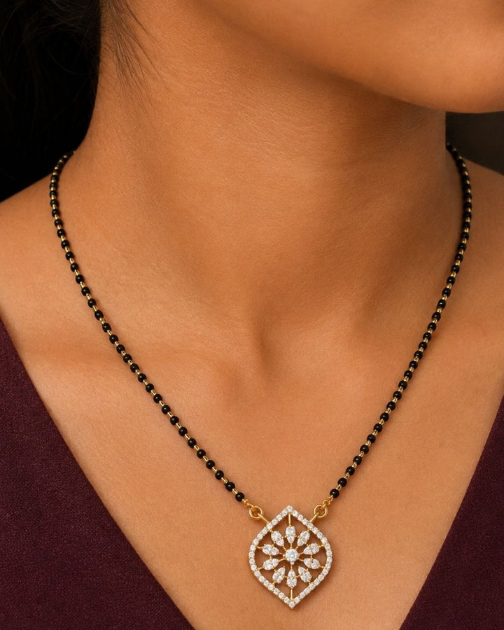 Beautiful black beads gold plated necklace set featuring a floral geometric pendant surrounded by sparkling stones, paired with matching earrings. Perfect for daily wear, festive occasions, traditional outfits, parties, and gifting.