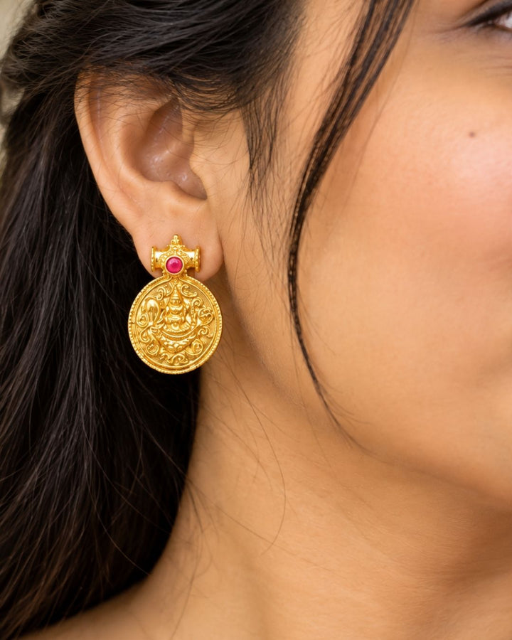 Traditional gold plated designer necklace and earrings set featuring multiple Goddess Lakshmi coin pendants, intricate temple-inspired detailing, ruby and green stone accents, and matching Lakshmi coin earrings, perfect for festive, wedding, and traditional occasions.