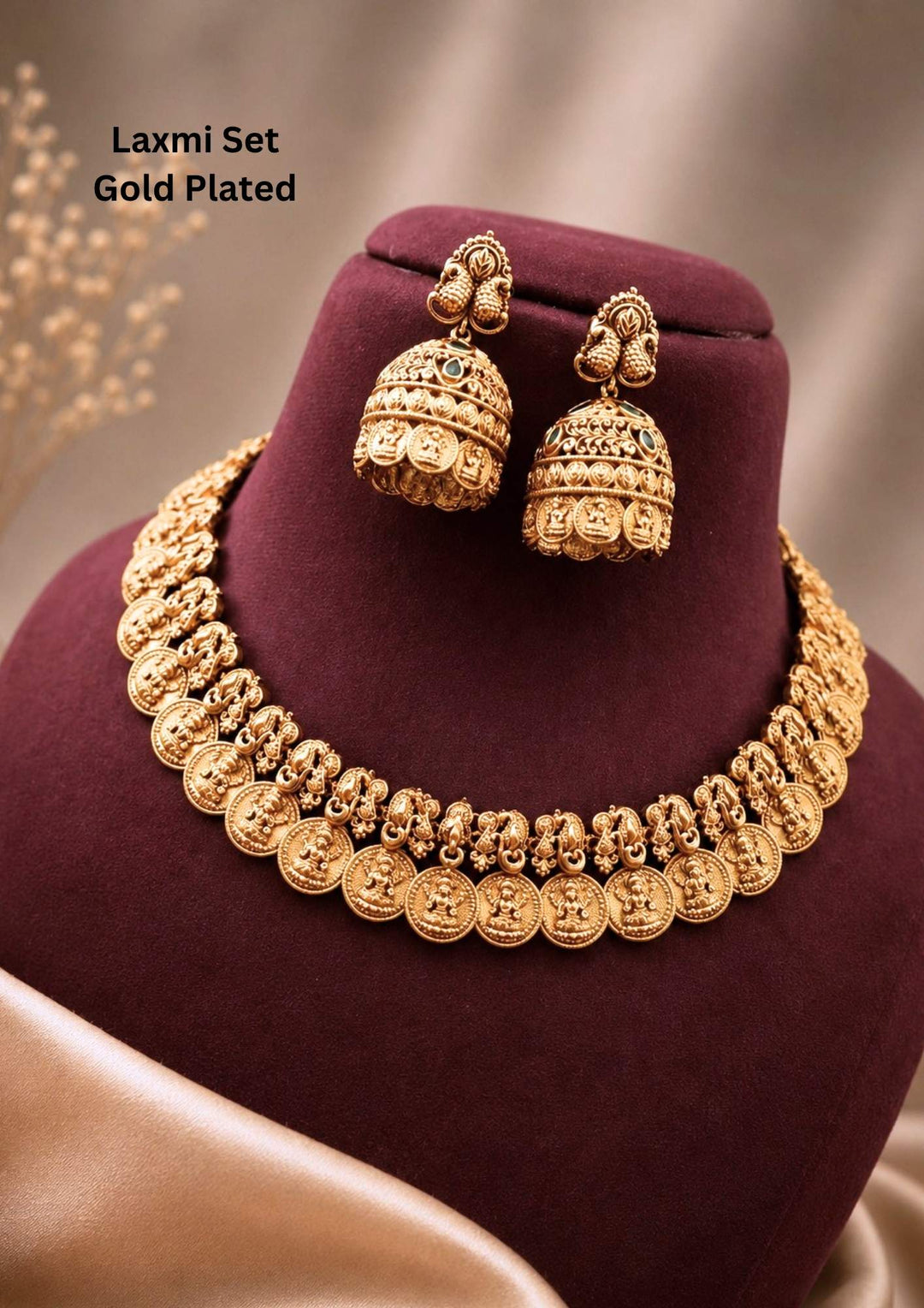 gold plated brass base temple jewelry kasu mala set featuring a structured collar necklace composed of traditional overlapping coins (kasu) embossed with the image of Goddess Lakshmi. The set comes with matching dome-shaped jhumka earrings featuring a delicate twin-peacock top stud and a matching coin border design at the base. Perfect for weddings, festivals, and family celebrations with skin-friendly premium quality, comfortable fitting