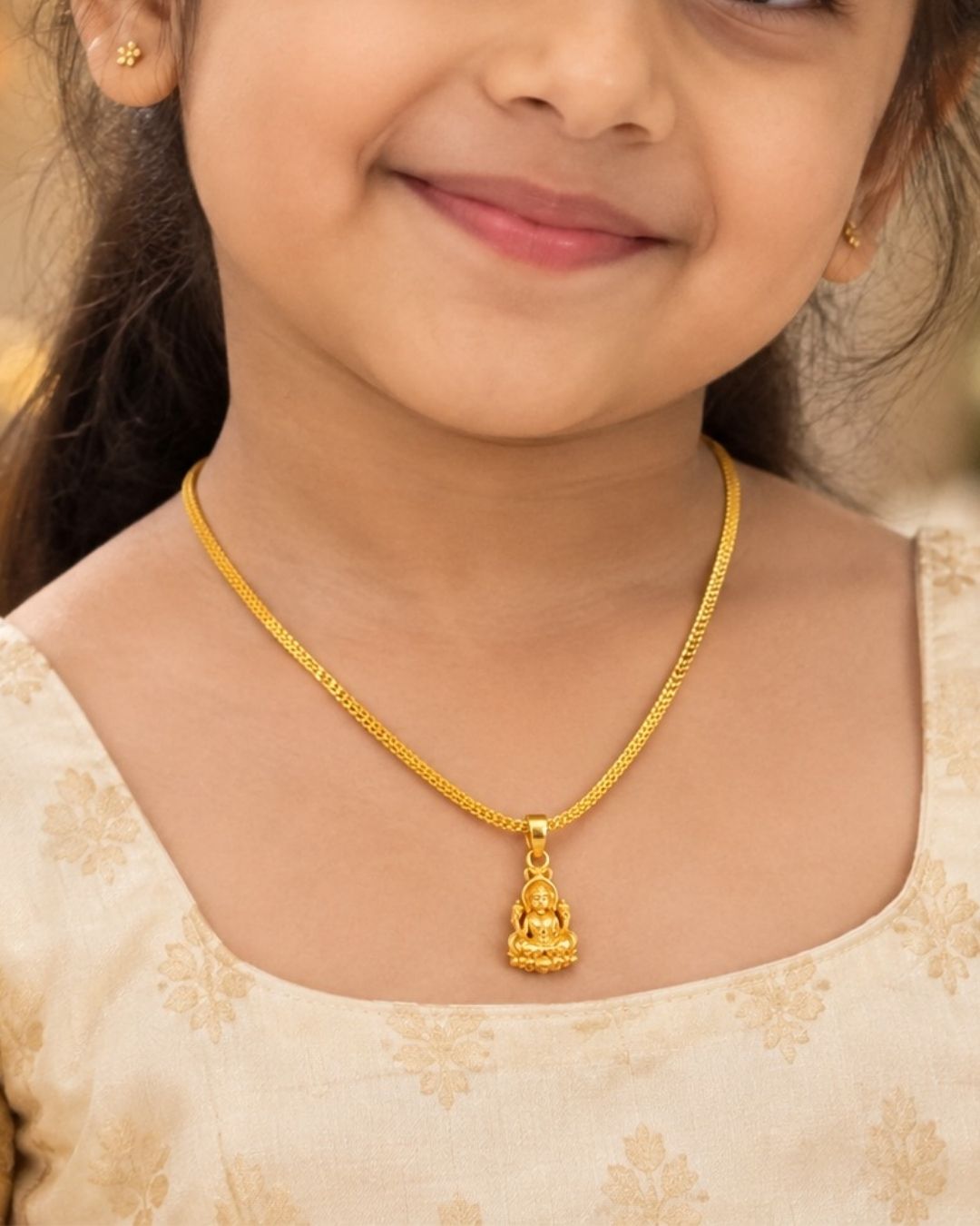 Beautiful gold plated necklace featuring a delicate textured chain and a traditional Lakshmi goddess pendant with intricate detailing. Perfect for traditional wear, festive occasions, weddings, daily wear, and gifting.