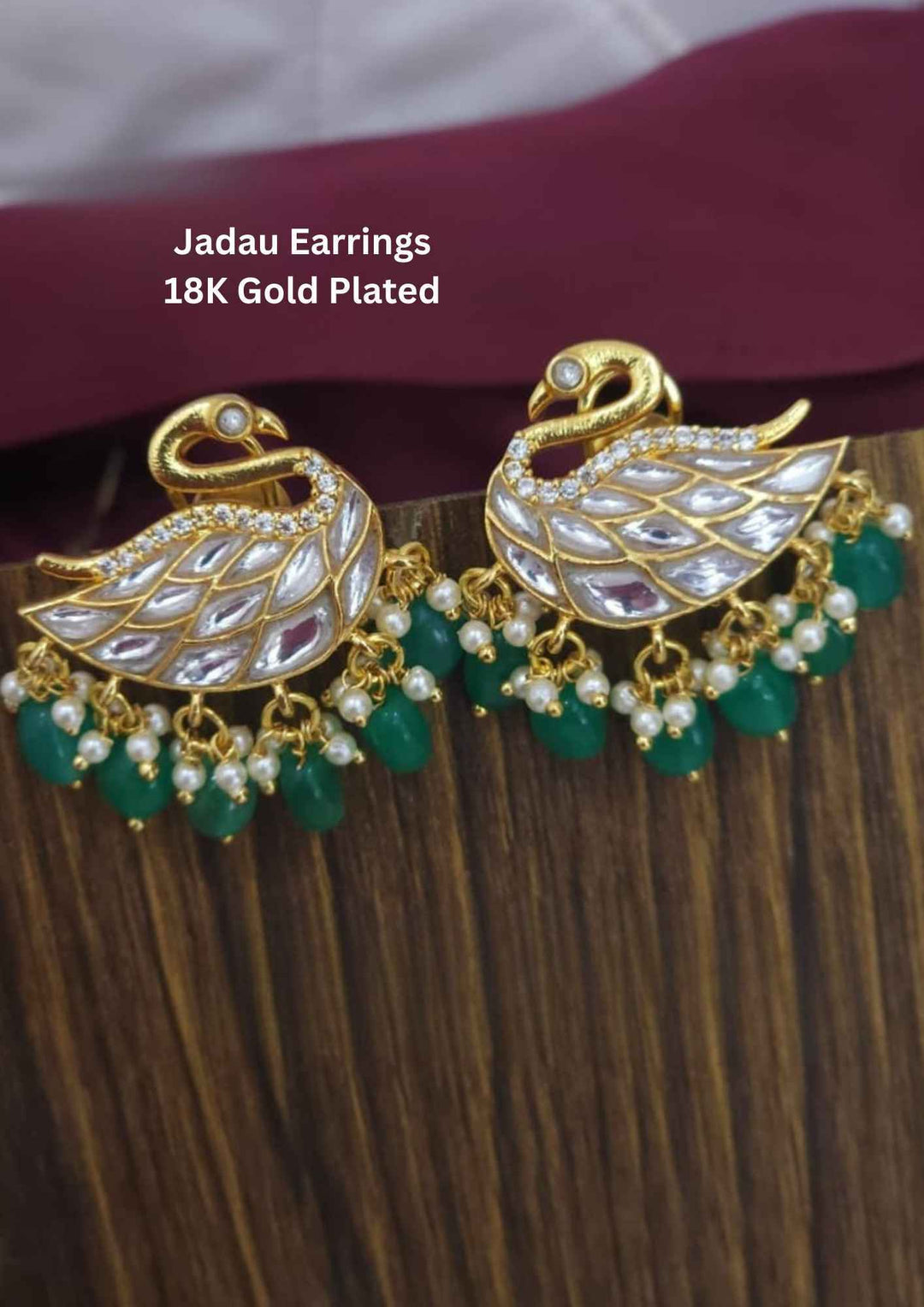 Gold-plated Jadau earrings with green stones
