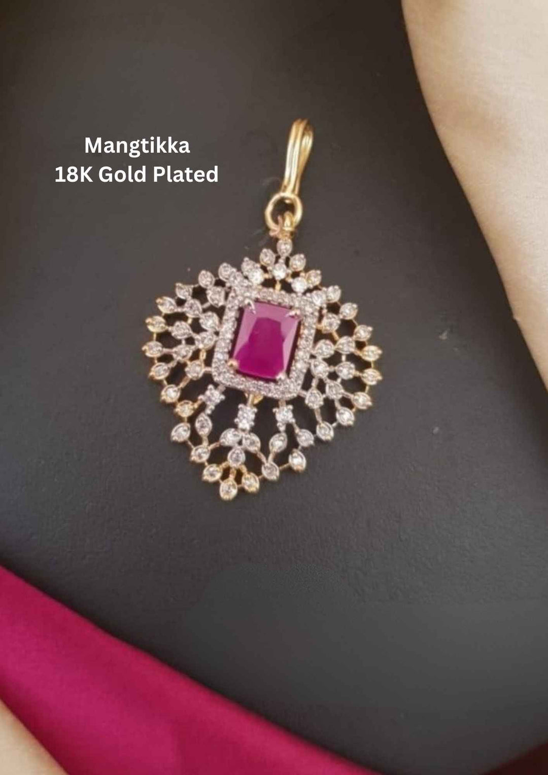 Gold-plated Mangtikka with a red gemstone 
