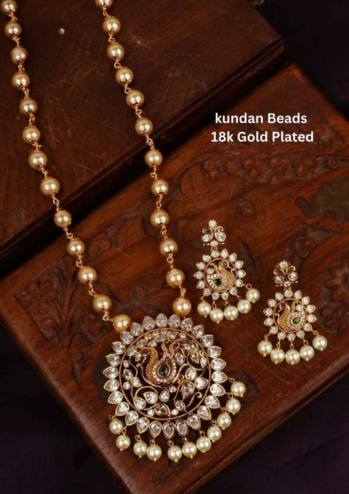 Gold-plated beads necklace set with matching earrings with green gemstones