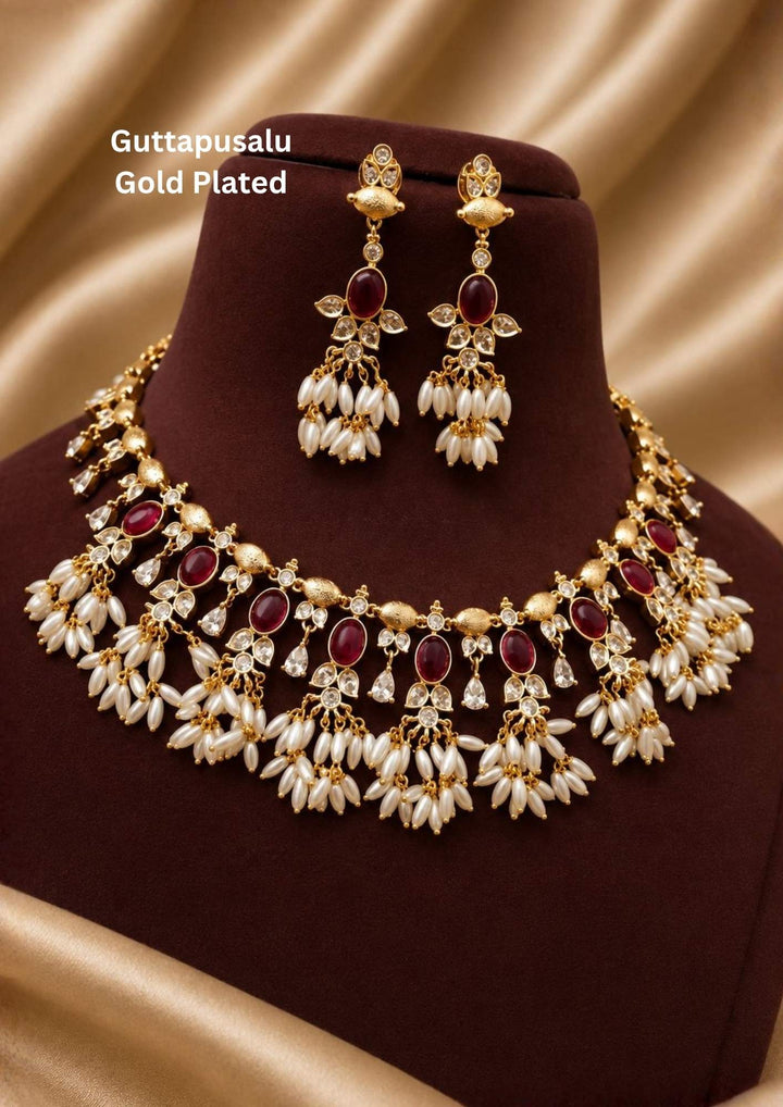 Gold-plated necklace and earrings set with pearls and gemstones comes with jadau kundan and it comes with in detailed peacock design and  comes with pearl beads and looks traditional for weeding , functional 