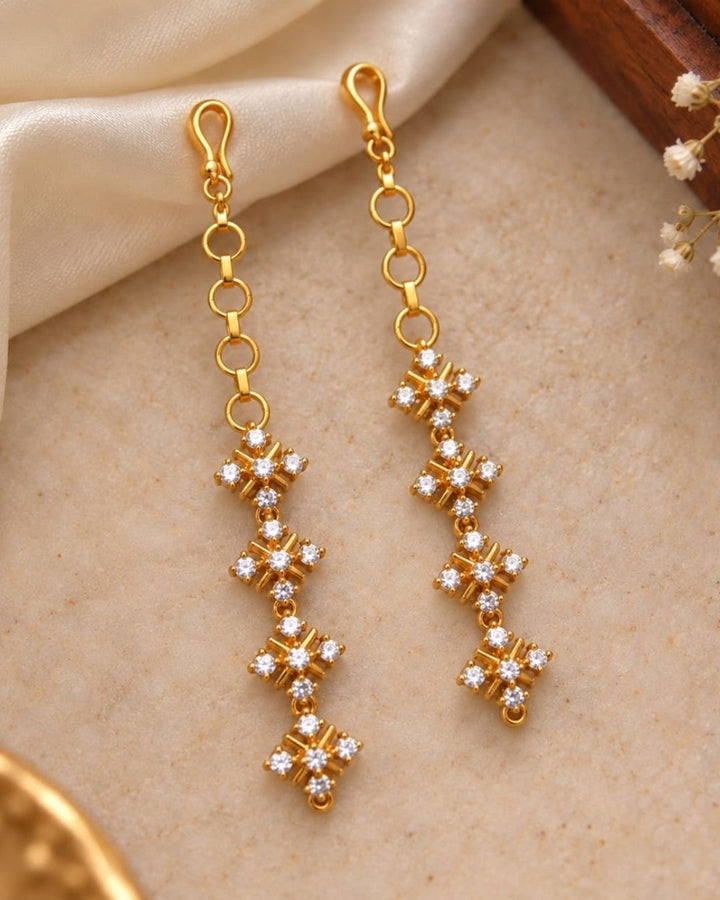 Elegant gold finish ear chains with four floral crystal stone designs arranged vertically for a traditional and sophisticated look.