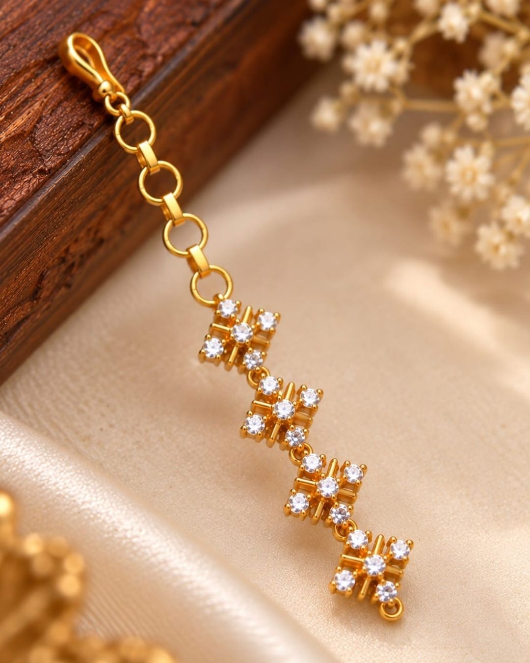 Elegant gold finish ear chains with four floral crystal stone designs arranged vertically for a traditional and sophisticated look.