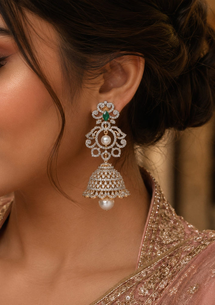 South indian women wearings a zircon diamond gold plated 4 in 1 green jhumkas and can be used like 4 ways and for all the parties cane used this are anti faded and skin safe and can be used for parties , festivals and weeding's 