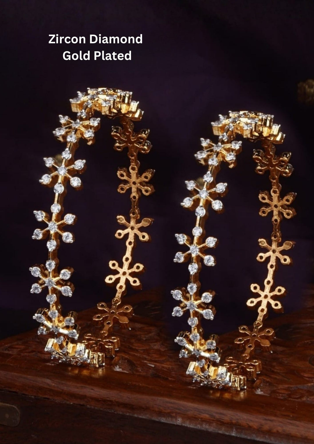 Gold Plated Amora Bangles with stylish flower-shaped zircon diamond design and detailed stone pattern all around the bangles. The bangles come with shiny gold plating, sparkling white zircon stones, lightweight feel, smooth finishing, sweat proof quality, anti-fade colour, and comfortable fit for daily wear, functions, festivals, weddings, and party jewelry collections  and for gifting. 