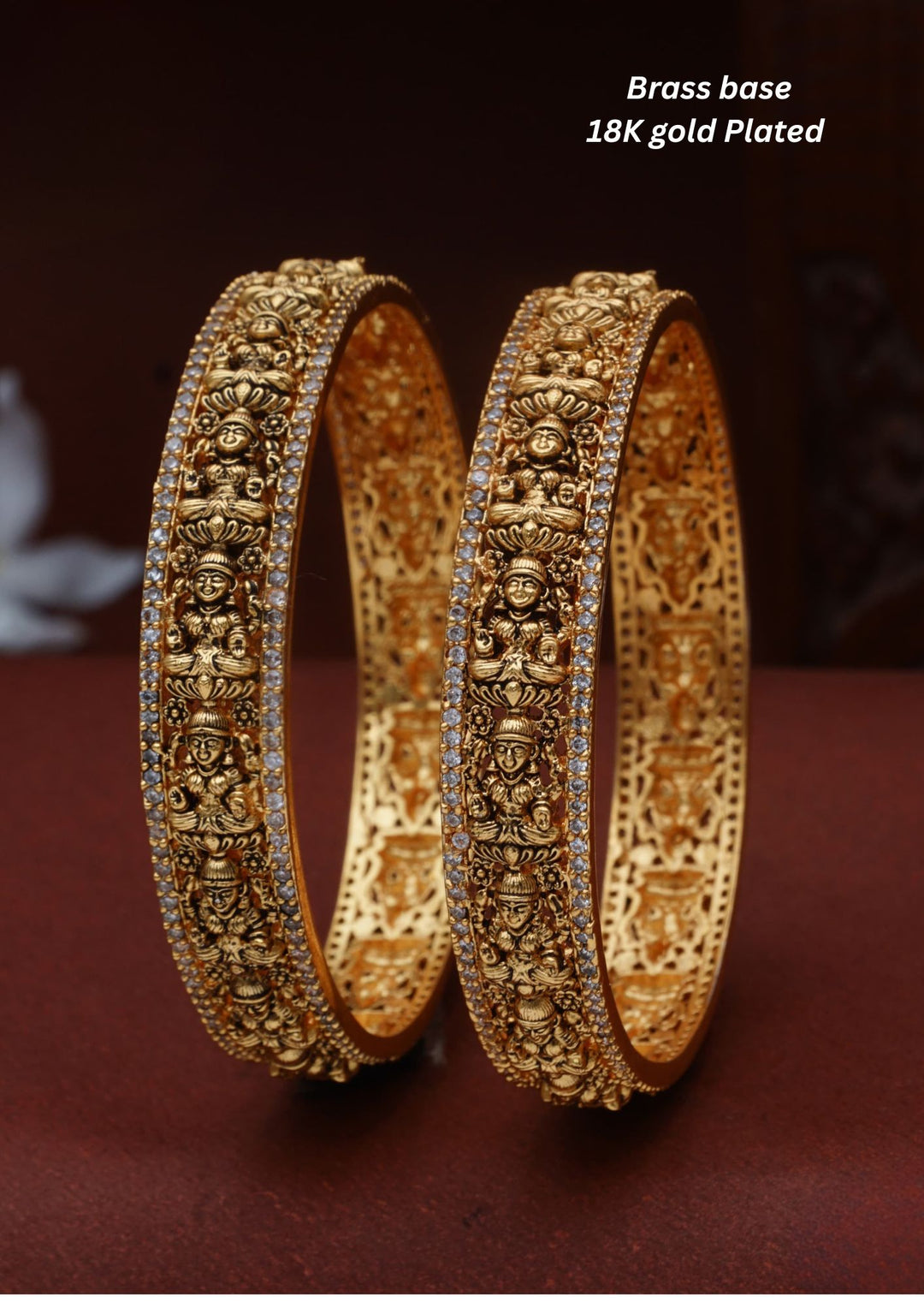 Elegant 18K gold plated designer bangles featuring repeated Goddess Lakshmi motifs, detailed craftsmanship, and zircon stone borders, perfect for festive and traditional wear.