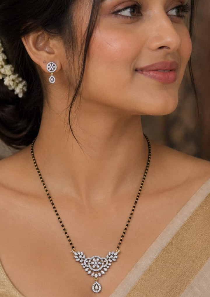 South Indian Woman wearing Gold plated black beads mangalsutra featuring an elegant butterfly-inspired zircon centerpiece with delicate curved detailing. Lightweight and classy crafted for everyday elegance, festive occasions, and gifting.