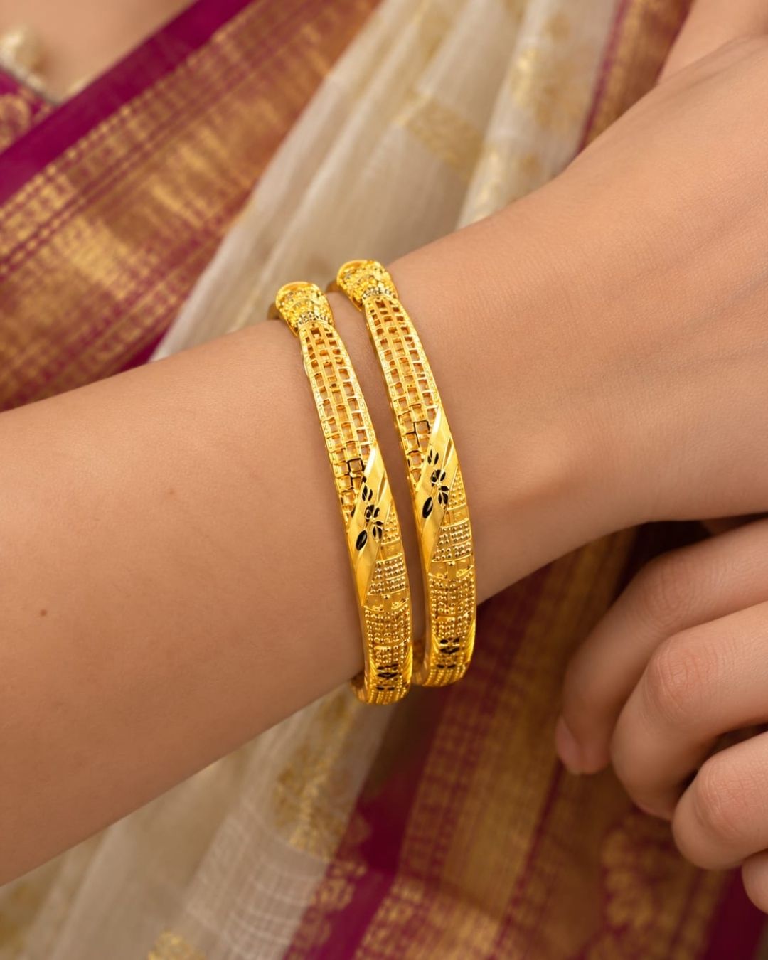 18K gold plated bangles featuring intricate geometric patterns, textured detailing, and black floral accents in an elegant traditional design.